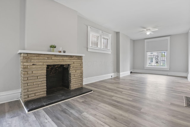 838 Wilson Ave, Columbus, OH 43206 - unfurnished living room featuring a fireplace, wood finished floors, ceiling fan, and baseboards