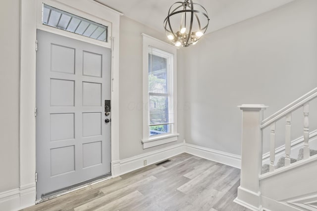 838 Wilson Ave, Columbus, OH 43206 - entrance foyer featuring a chandelier, wood finished floors, stairway, and baseboards
