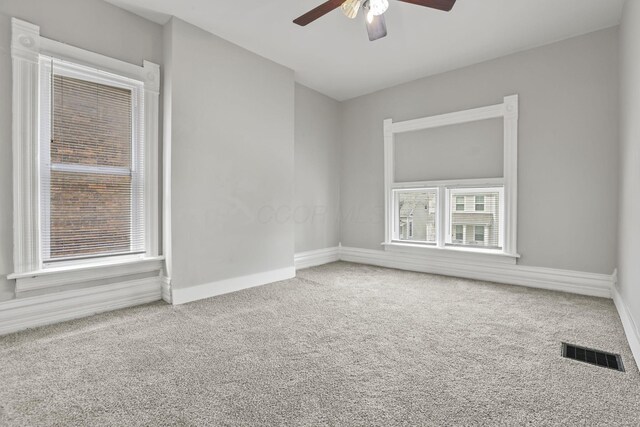 838 Wilson Ave, Columbus, OH 43206 - spare room with a ceiling fan, carpet flooring, and baseboards