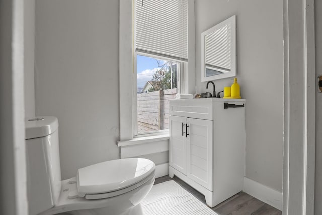 838 Wilson Ave, Columbus, OH 43206 - bathroom with toilet, vanity, and wood finished floors