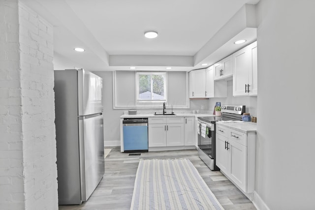 838 Wilson Ave, Columbus, OH 43206 - kitchen featuring appliances with stainless steel finishes, a sink, white cabinets, light countertops, and recessed lighting