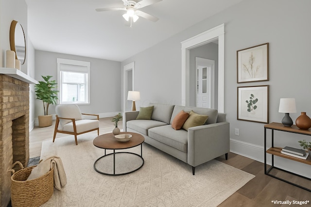 838 Wilson Ave, Columbus, OH 43206 - living room featuring wood finished floors, a ceiling fan, baseboards, and a brick fireplace