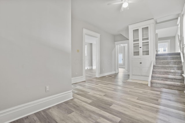 838 Wilson Ave, Columbus, OH 43206 - unfurnished living room featuring a ceiling fan, light wood-type flooring, stairway, and baseboards