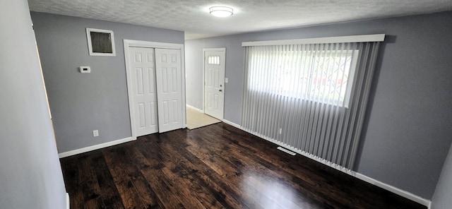 3087 Woodway Rd, Columbus, OH 43207 - unfurnished bedroom with wood finished floors, a textured ceiling, baseboards, and a closet