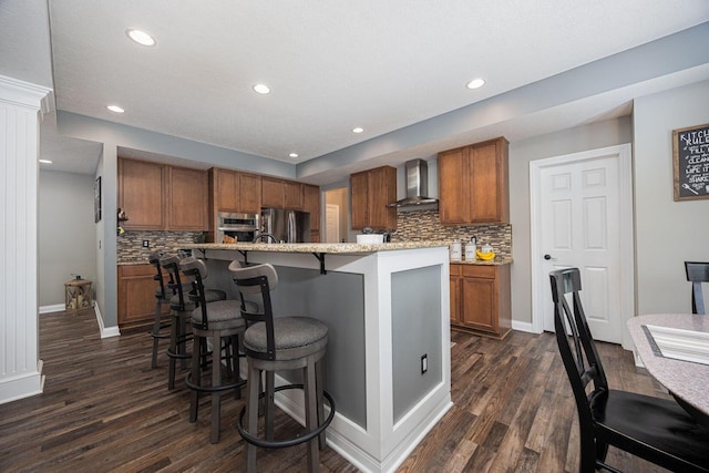 1923 Mallow Ln, Grove City, OH 43123 - kitchen with wall chimney exhaust hood, brown cabinetry, freestanding refrigerator, dark wood-type flooring, and recessed lighting