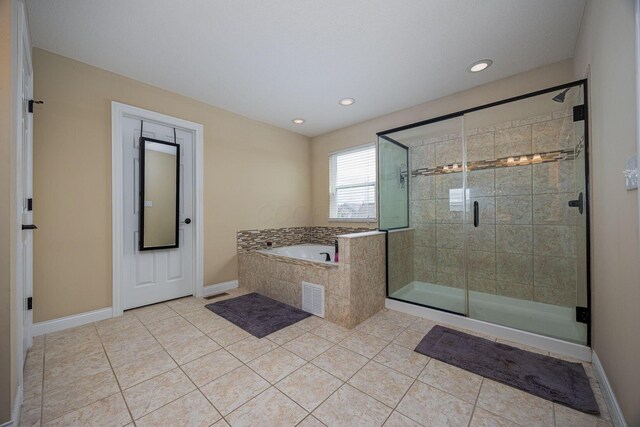 1923 Mallow Ln, Grove City, OH 43123 - bathroom featuring a garden tub, tile patterned flooring, a stall shower, recessed lighting, and baseboards