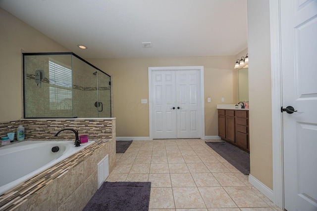 1923 Mallow Ln, Grove City, OH 43123 - bathroom with a stall shower, vanity, a garden tub, tile patterned floors, and baseboards