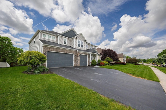 1923 Mallow Ln, Grove City, OH 43123 - view of front facade featuring a garage, driveway, a front lawn, and stone siding