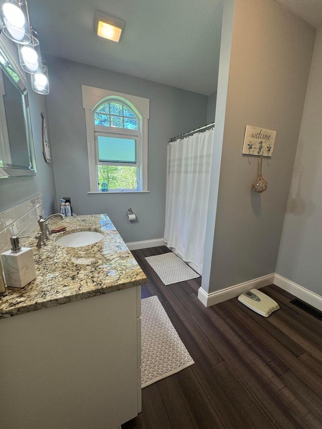8610 Sadie Thomas Rd NW, Johnstown, OH 43031 - full bath with wood finished floors, baseboards, vanity, and a shower with curtain