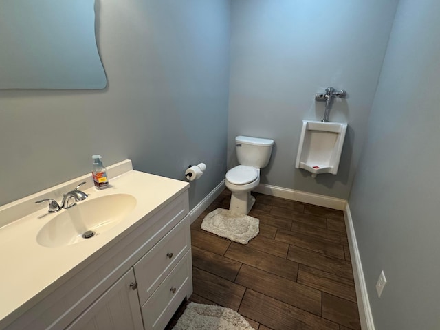 8610 Sadie Thomas Rd NW, Johnstown, OH 43031 - half bathroom featuring wood tiled floors, toilet, baseboards, and vanity