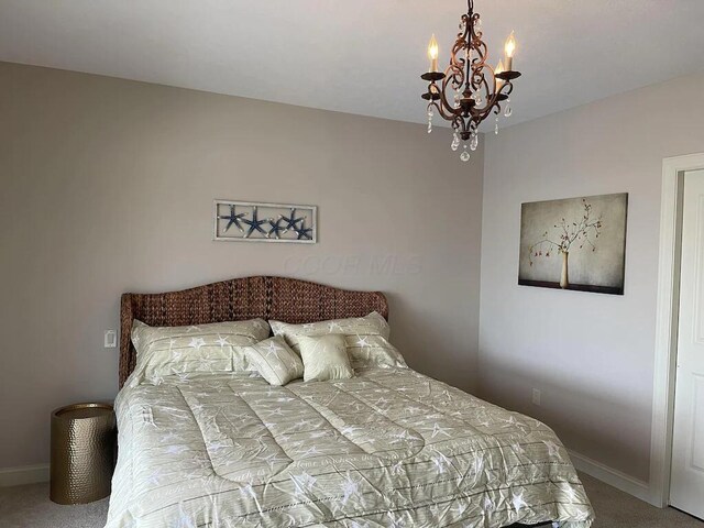 3348 W Erie Ave, Lorain, OH 44053 - carpeted bedroom featuring baseboards and an inviting chandelier