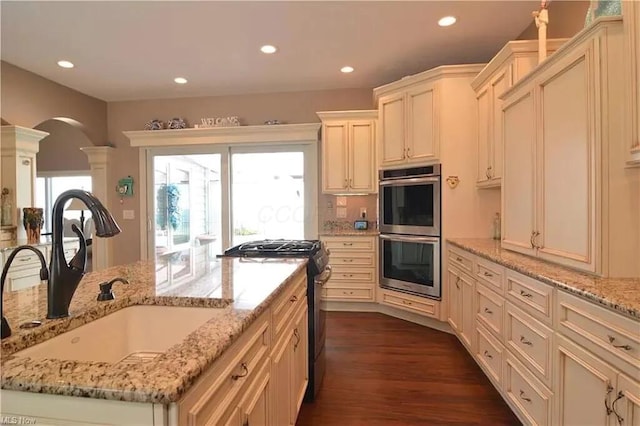 3348 W Erie Ave, Lorain, OH 44053 - kitchen with a sink, stainless steel appliances, decorative columns, recessed lighting, and arched walkways