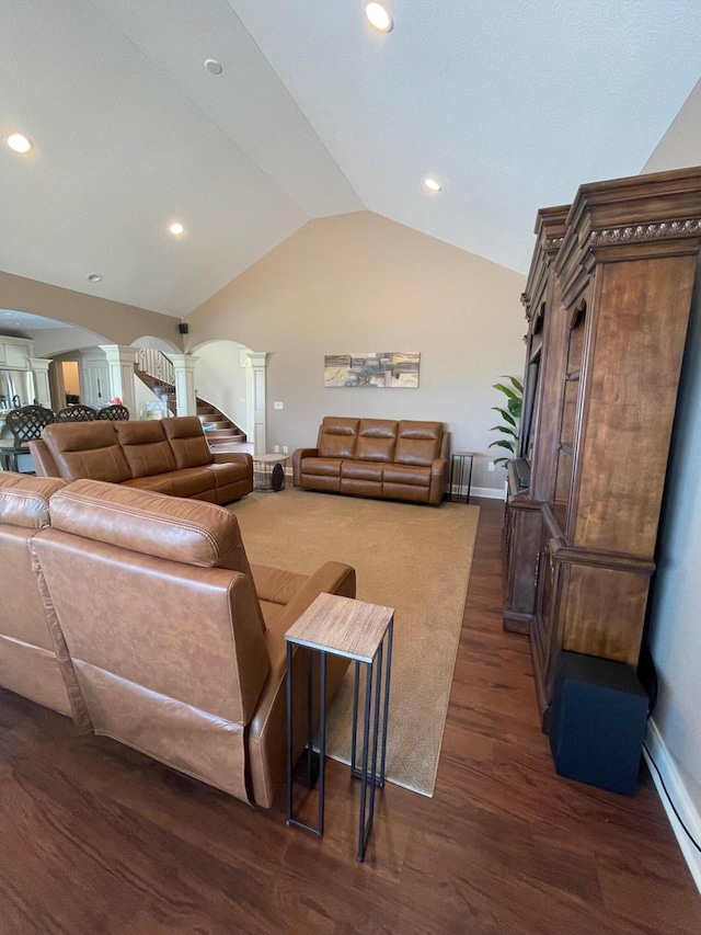 3348 W Erie Ave, Lorain, OH 44053 - living room with baseboards, decorative columns, vaulted ceiling, arched walkways, and dark wood-style floors