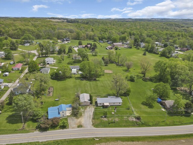birds eye view of property featuring a wooded view