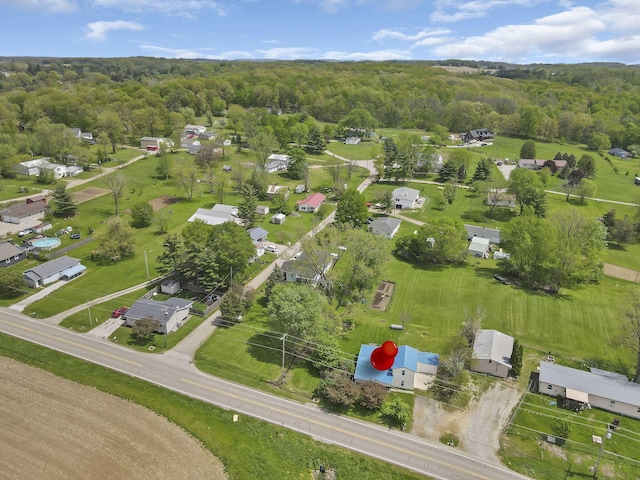 birds eye view of property featuring a wooded view