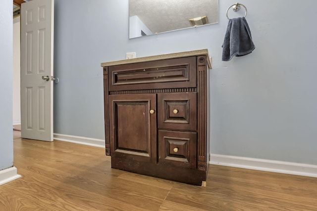 details with baseboards and wood finished floors