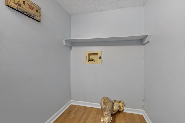 laundry room featuring wood finished floors, laundry area, washer hookup, a textured ceiling, and baseboards
