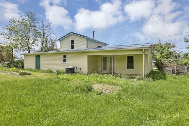 back of property with cooling unit and metal roof