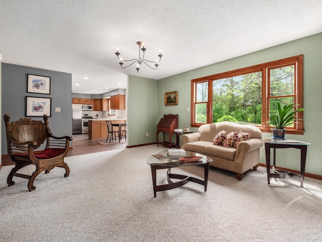 living area featuring light carpet, a chandelier, a textured ceiling, baseboards, and recessed lighting