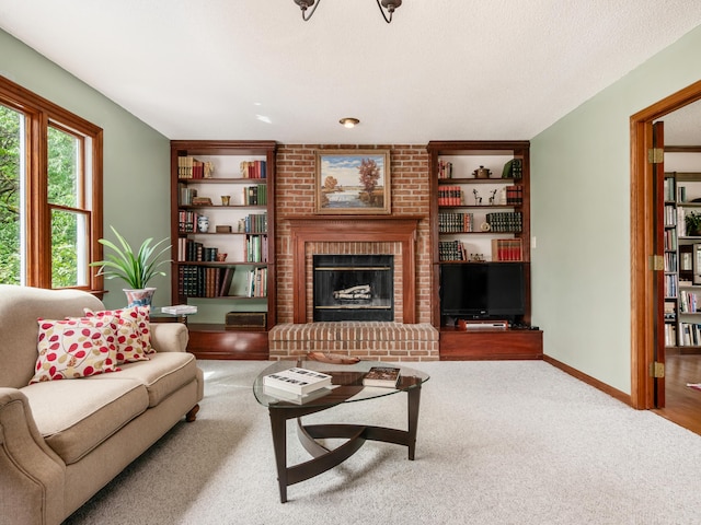carpeted living area featuring built in shelves, a brick fireplace, and baseboards