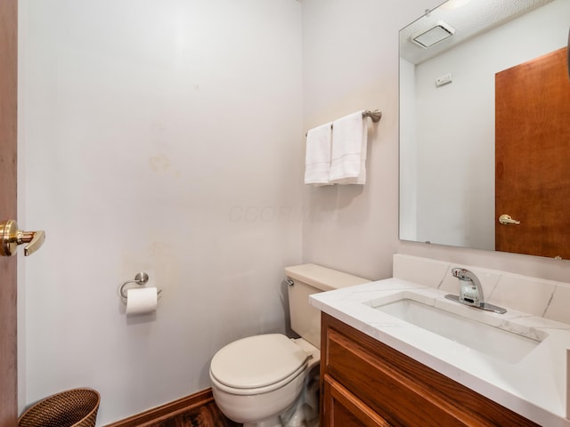 bathroom with toilet and vanity