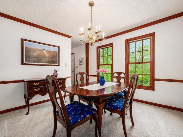 dining area featuring light colored carpet, baseboards, a chandelier, and ornamental molding