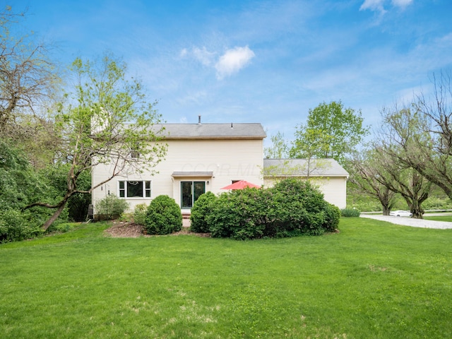back of house with a lawn