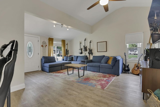 265 E St, Buckeye Lake, OH 43008 - living area featuring lofted ceiling, healthy amount of natural light, ceiling fan, wood finished floors, and baseboards