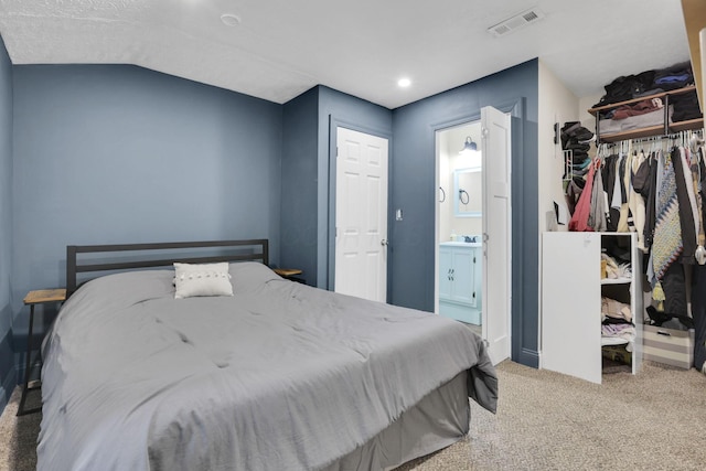 265 E St, Buckeye Lake, OH 43008 - carpeted bedroom featuring ensuite bath, a sink, a closet, vaulted ceiling, and baseboards