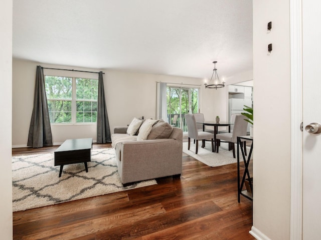 2059 Park Run Dr Unit D, Columbus, OH 43220 - living room featuring an inviting chandelier and dark wood-style floors
