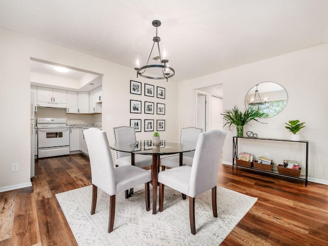 2059 Park Run Dr Unit D, Columbus, OH 43220 - dining area with dark wood-style flooring, baseboards, and a notable chandelier