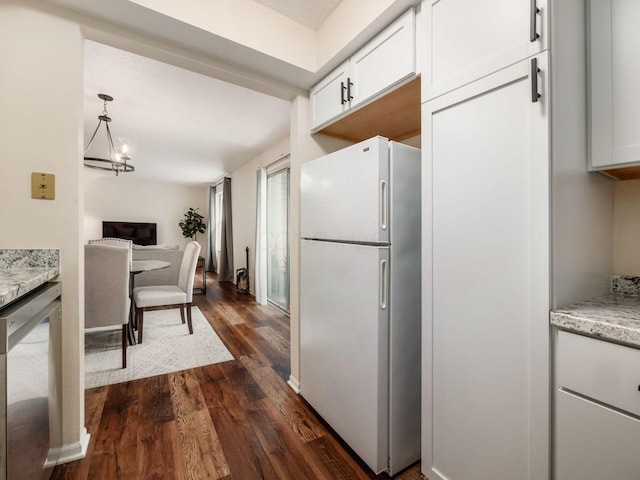 2059 Park Run Dr Unit D, Columbus, OH 43220 - kitchen with freestanding refrigerator, a notable chandelier, white cabinetry, dark wood-style flooring, and light stone countertops