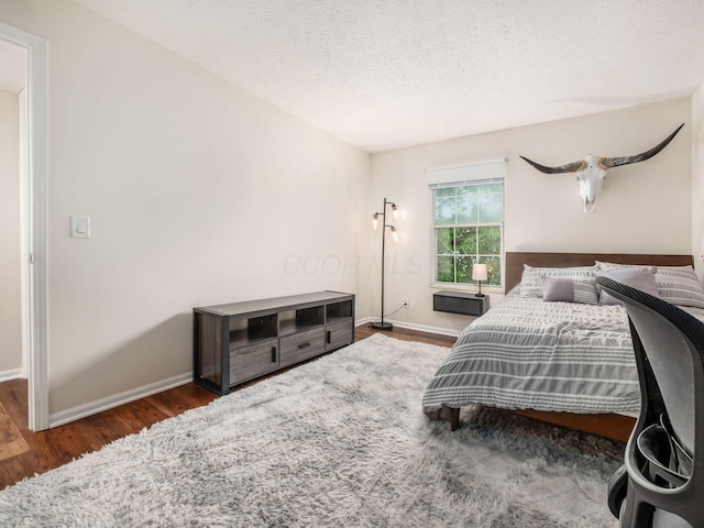 2059 Park Run Dr Unit D, Columbus, OH 43220 - bedroom with baseboards, a textured ceiling, and wood finished floors