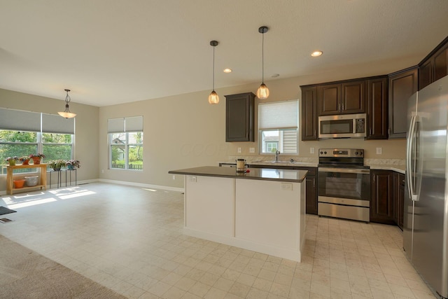 6332 Celeste St, Westerville, OH 43081 - kitchen featuring dark brown cabinets, appliances with stainless steel finishes, plenty of natural light, and a sink