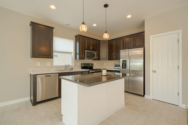 6332 Celeste St, Westerville, OH 43081 - kitchen with dark brown cabinets, recessed lighting, a sink, appliances with stainless steel finishes, and decorative light fixtures