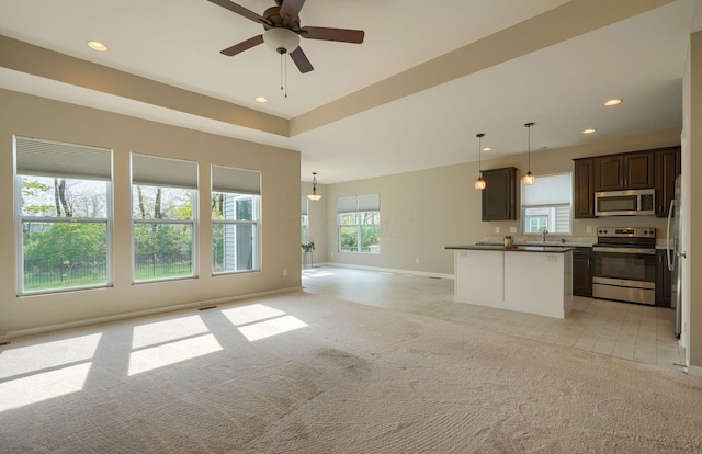 6332 Celeste St, Westerville, OH 43081 - unfurnished living room featuring a sink, baseboards, light carpet, and a ceiling fan