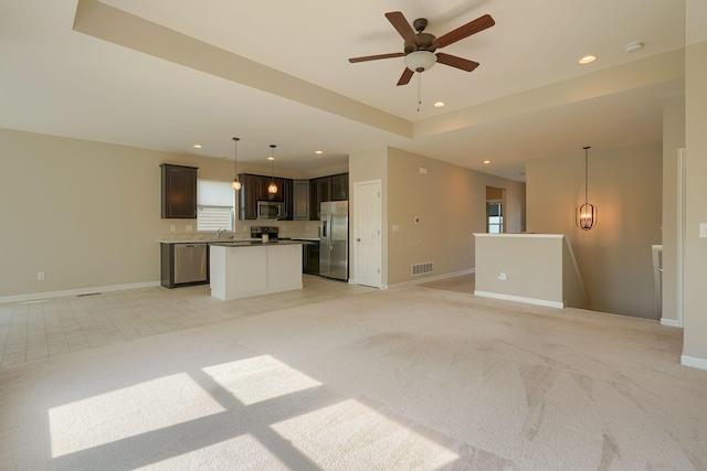 6332 Celeste St, Westerville, OH 43081 - unfurnished living room with visible vents, a ceiling fan, baseboards, and light colored carpet