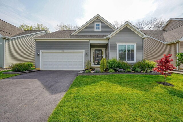 6332 Celeste St, Westerville, OH 43081 - view of front of house with a garage, a shingled roof, driveway, and a front lawn
