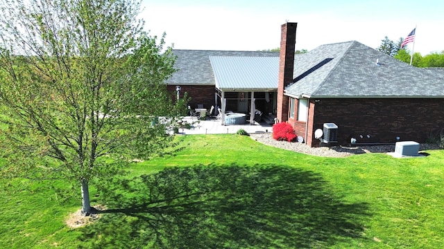 1305 Bald Hill Rd, Zanesville, OH 43701 - back of property with a chimney, a lawn, a patio, cooling unit, and brick siding
