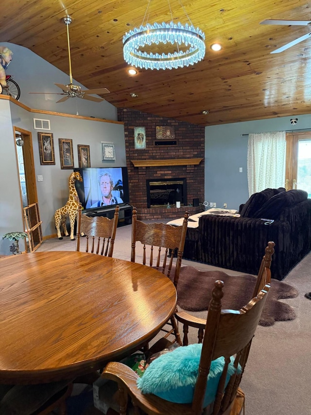 1305 Bald Hill Rd, Zanesville, OH 43701 - carpeted dining area with a ceiling fan, vaulted ceiling, wooden ceiling, a fireplace, and a chandelier
