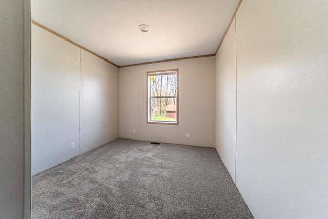 carpeted empty room featuring visible vents