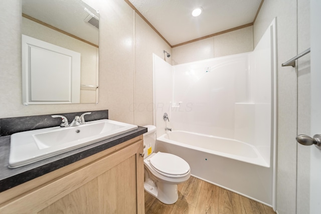 full bath with vanity, ornamental molding, shower / bathtub combination, wood finished floors, and toilet