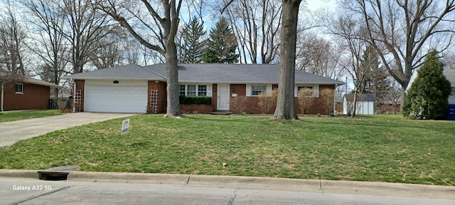 ranch-style home featuring an attached garage, driveway, brick siding, and a front yard