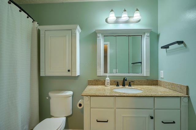 bathroom with toilet and vanity