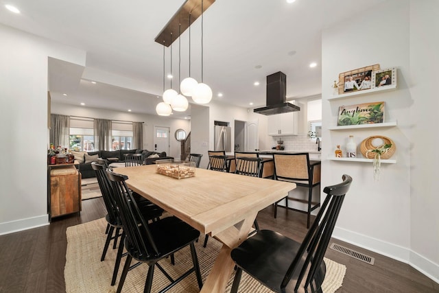 dining area with baseboards, dark wood-style floors, and visible vents