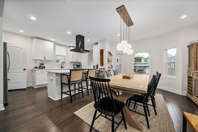 dining area with dark wood-style flooring, baseboards, and recessed lighting