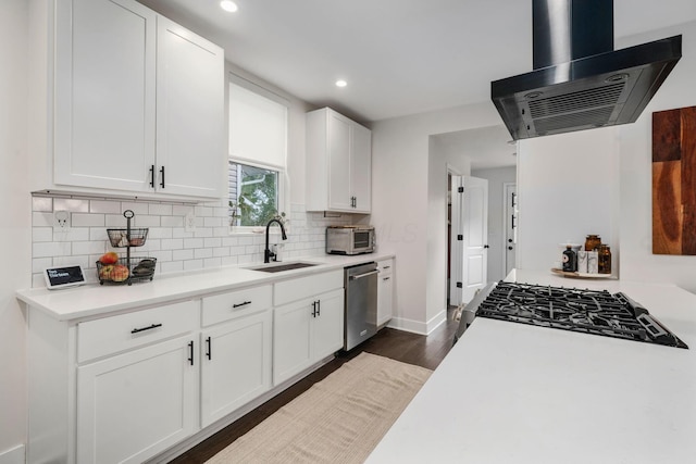kitchen with decorative backsplash, recessed lighting, ventilation hood, a sink, and appliances with stainless steel finishes