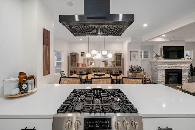 kitchen with decorative light fixtures, a fireplace, open floor plan, recessed lighting, and extractor fan