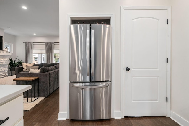 kitchen with light countertops, baseboards, freestanding refrigerator, recessed lighting, and dark wood-type flooring