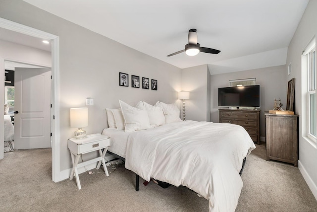 bedroom with light colored carpet, baseboards, ceiling fan, and visible vents